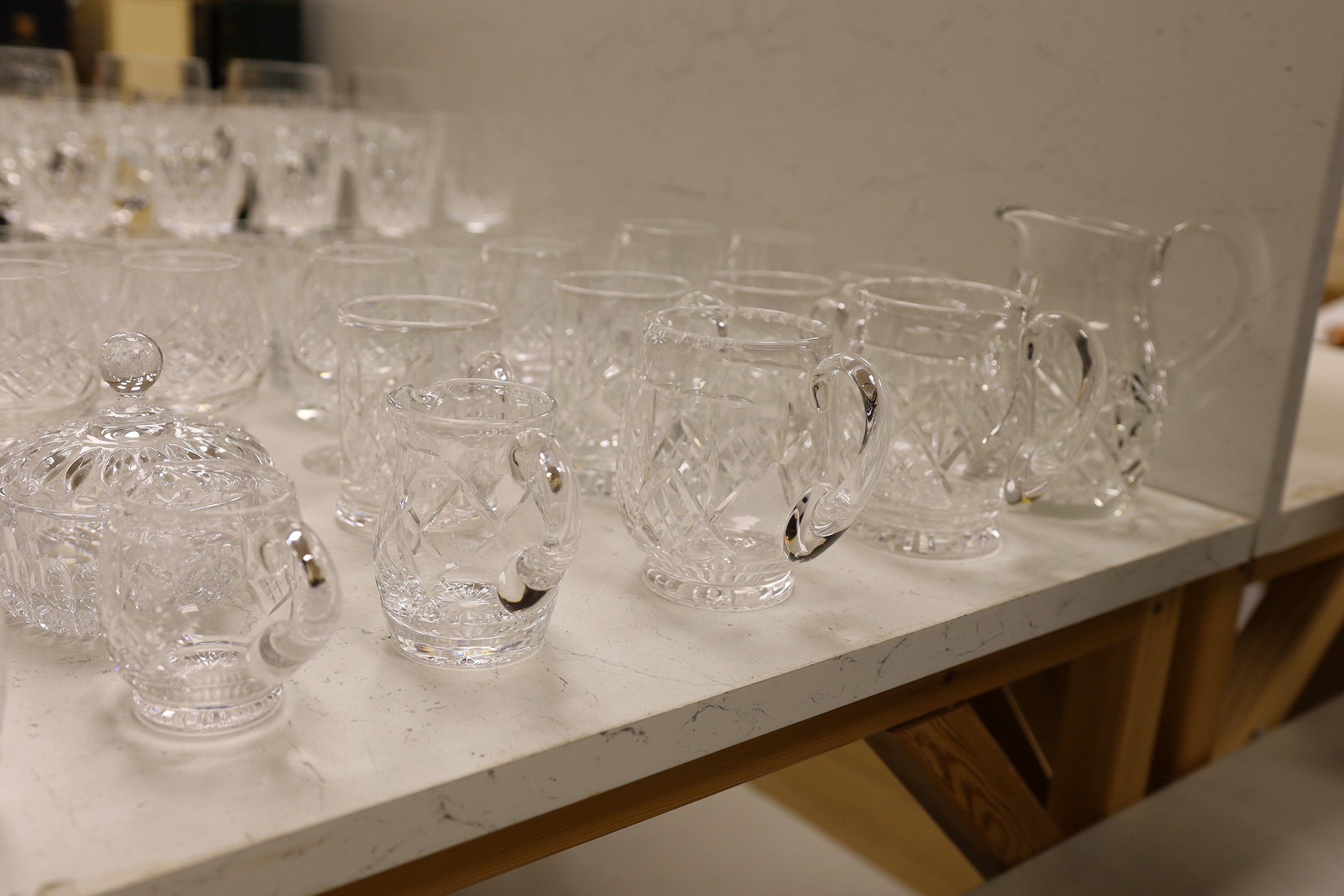 A large collection of suites of mostly Stuart cut glass, including, wine glasses, spirits glasses and jugs